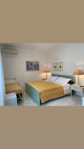 a bedroom with two beds and two tables at Pi.Lù. Bed and breakfast in Borgo