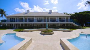 a large house with two pools in front of it at The Dover House Resort in Delray Beach