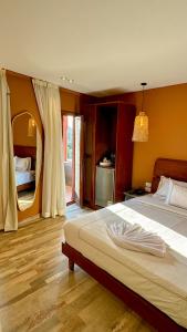 a bedroom with a large bed and a mirror at Almas Pyramids Hotel in Cairo