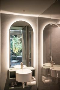 a bathroom with two sinks and a mirror at Mynt Merano Rooms in Merano