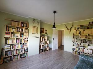 a room with several bookshelves filled with books at Dom w Siedlisku pod Orzechem 