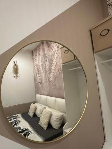 a mirror in a room with a shelf and pillows at Ferienwohnung Lauri in Bayreuth