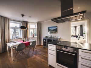 a kitchen with a table and a dining room at Holiday apartment Waldfrieden in Kurort Bärenburg