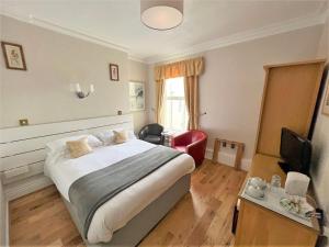 a hotel room with a bed and a television at The Ashley in Morecambe