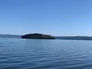 an island in the middle of a large body of water at Casalago in Bolsena