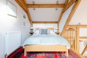 a bedroom with a large bed in a attic at Little Trenant Barn on Helford River Near Constantine in Constantine