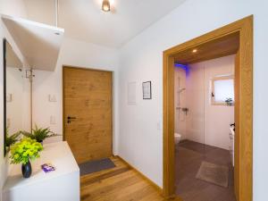 a bathroom with a wooden door and a toilet at AlpenLuxus' ALTE MÜHLE LOFT with balcony & car park in Brixlegg