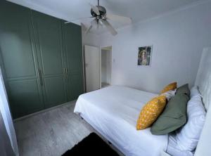 a bedroom with a bed with a pineapple pillow on it at DMK GUESTHOUSE 2 in Cape Town