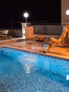 a swimming pool with a water fall in the middle at Apartments Mediteran in Ulcinj