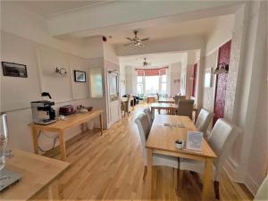 a dining room and living room with a table and chairs at The Ashley in Morecambe