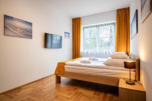 a bedroom with a bed and a window at Willa Aga in Dębki