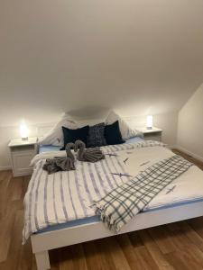 1 dormitorio con 1 cama con manta y 2 mesitas de noche en FroschKönig en Norden