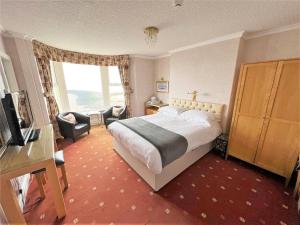 a hotel room with a bed and a window at The Ashley in Morecambe
