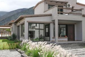 a house with a mountain in the background at Moller Masi - Ayllu Huasi in Purmamarca