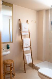 a ladder towel rack in a bathroom with a mirror at Rooms by JovA in El Campello