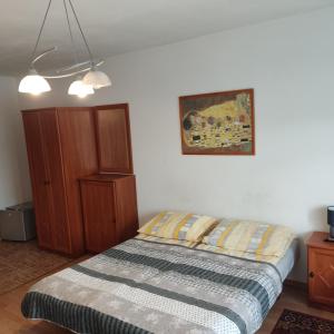 a bedroom with a bed and a picture on the wall at Pensjonat Aida in Kołobrzeg