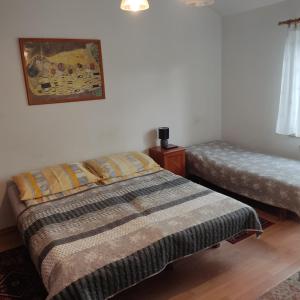 a bedroom with two beds and a picture on the wall at Pensjonat Aida in Kołobrzeg