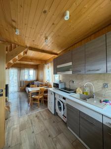 a kitchen with a sink and a stove top oven at Domki całoroczne KATRINA in Krynica Morska