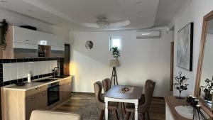 cocina con mesa y sillas en una habitación en Airport SKY apartments LUX en Belgrado