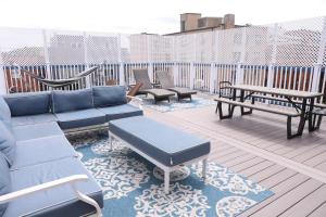 a patio with a couch and benches on a deck at Duo Housing in Washington, D.C.