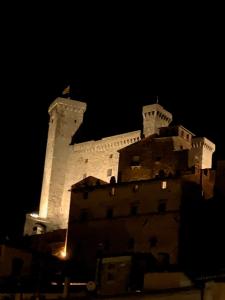 a castle at night with its lights on at Casalago in Bolsena +1 photo