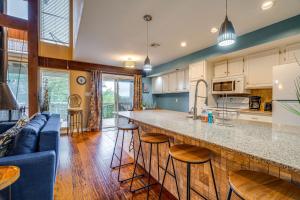 a kitchen and living room with a large counter top at Lago Vista Golf Getaway with Decks and Pool Access! in Lago Vista