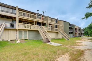 an apartment building with stairs in front of it at Lago Vista Golf Getaway with Decks and Pool Access! in Lago Vista