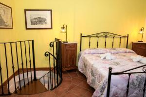 a bedroom with a bed in a room with yellow walls at Ca' Tonino in Bagnone