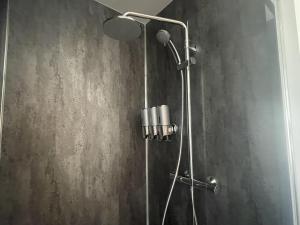 a bathroom with a shower with a shower head at Inverness luxury highland NC500 hideaway in Inverness