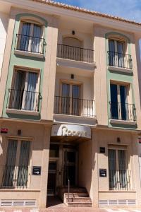a building with a sign that reads roberto at Rooms by JovA in El Campello