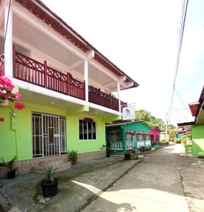 ein farbenfrohes Gebäude mit Balkon auf einer Straße in der Unterkunft Belo Bay Apartment Hotel in Portobelo