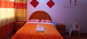 Postel nebo postele na pokoji v ubytování HOSTAL ACUARIUS PUNO
