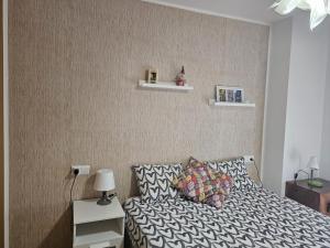 a bedroom with a bed and a wall with shelves at ENJOY VALDELINARES in Valdelinares