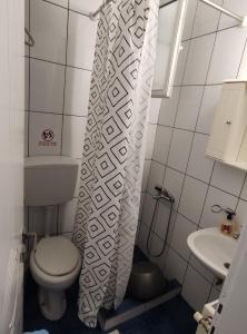 a small bathroom with a toilet and a sink at White coral 2 in Paralia Katerinis