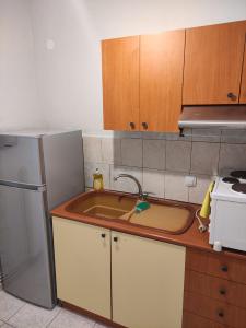 a kitchen with a sink and a refrigerator at White coral 2 in Paralia Katerinis