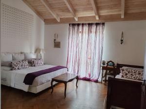 a bedroom with a bed and a table and a window at Taverna Centomani in Potenza