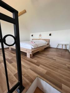 a bedroom with a bed and wooden floors at Zlatna Jabuka Lux in Prijepolje