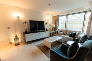 a living room with a couch and a tv at the best charming condo on the Nile in Cairo