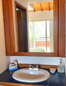 a bathroom with a sink and a mirror at Palma Sol in Pampatar