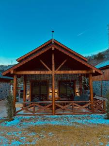 a log cabin with a wooden fence in front of it at Haremi Garden Suit Bungalovs 