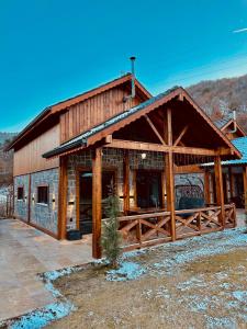 a large wooden cabin with a roof at Haremi Garden Suit Bungalovs 