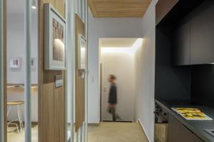 a person walking into a kitchen with a hallway at Heritage & Tales: Sihna in Litochoro +31 photos