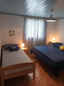 1 dormitorio con 2 camas y ventana en ANNA en Biograd na Moru