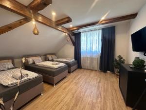 a living room with two beds and a large window at Ferienwohnung Missa in Bayreuth