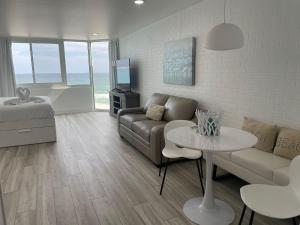 a living room with a couch and a table at Top of the Gulf 815 in Panama City Beach
