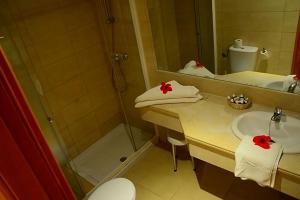 a bathroom with a shower and a sink and a toilet at Royal Lido Resort & Spa in El Fehri