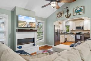 a living room with a couch and a kitchen at Pawleys Island Retreat 4 Bedroom Haven in Pawleys Island