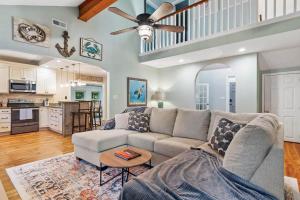 a living room with a couch and a table at Pawleys Island Retreat 4 Bedroom Haven in Pawleys Island