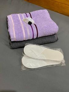 a pair of purple towels and a plastic bag at Elegant hideaway in Manchester
