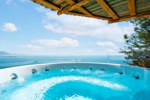 a hot tub with a view of the ocean at Laguna Blu - Resort Villa overlooking the sea on the Amalfi Coast in Vietri